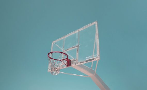 Basketball hoop against a solid blue background