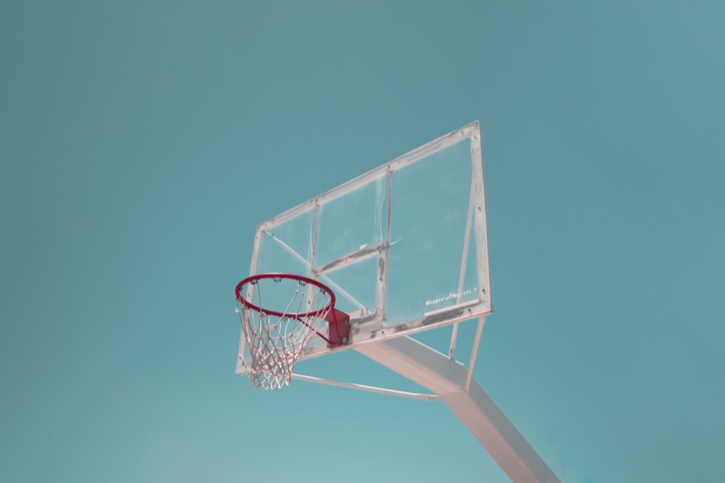 Basketball hoop against a solid blue background