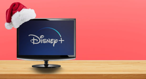 Santa hat sitting on top of a computer monitor with Disney plus on screen