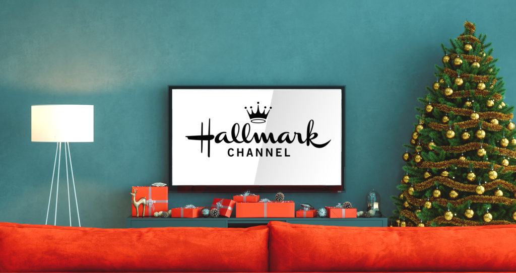 Hallmark channel on a tv in a living room decorated for the holidays