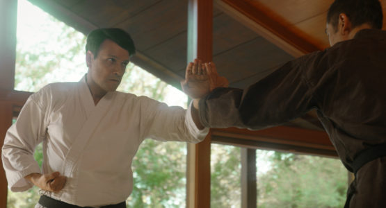 Men practicing karate in Cobra Kai