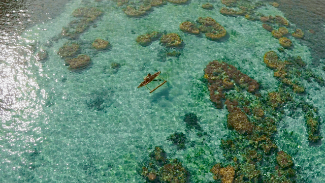 Outrigger canoe in clear tropical waters
